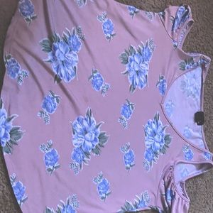 It is a lavender shirts with sleeves of and blue flowers